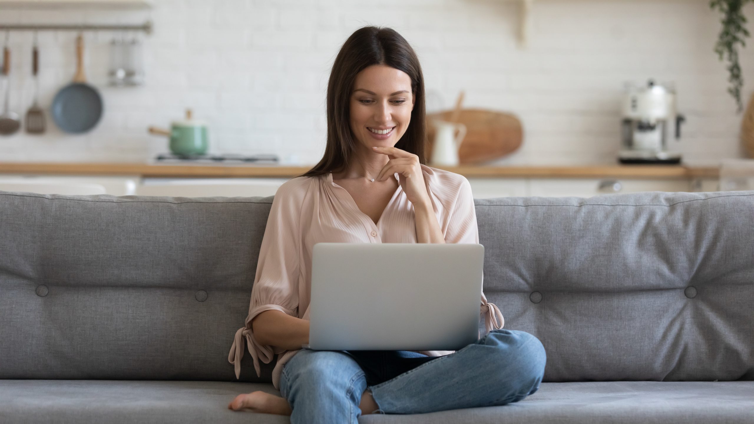 Smiling woman scrolling through an Italian food online store.